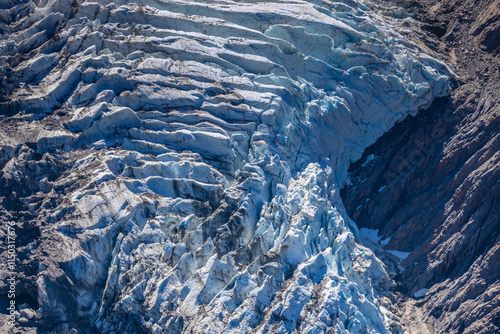 Glacier le Bossons in the french Alps, Chamonix valley, Montblanc. The glacier crevasse and huge serac with blue ice on slopes of Mont Blanc. Melting glacier caused by climate change global warming