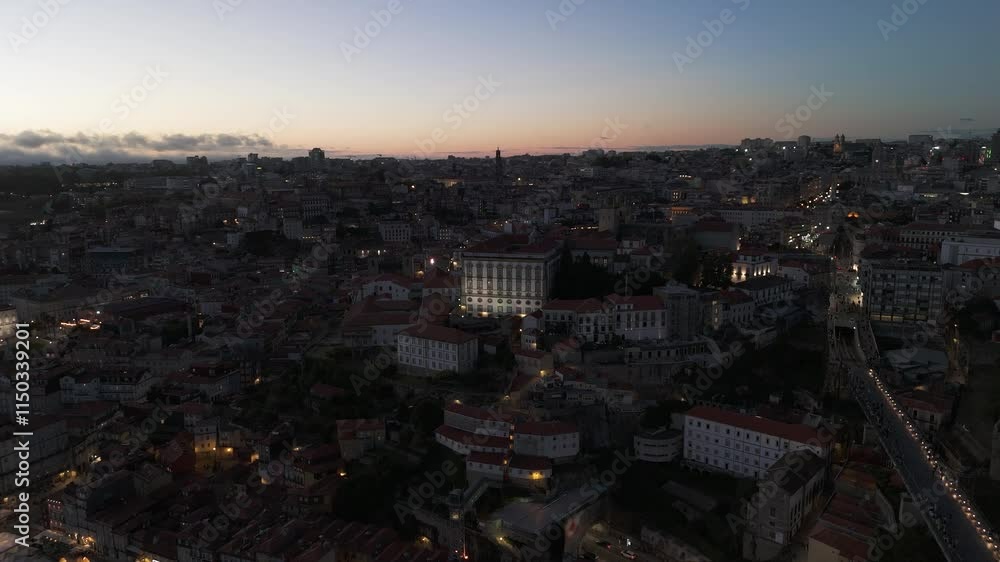 Illuminated Porto City at Evening Twilight. Episcopal Palace and Porto Cathedral. Aerial Drone Shot. Portugal. Orbiting Illuminated Porto City at Evening Twilight. Episcopal Palace and Porto Cathedral. Aerial Drone Shot. Portugal. Orbiting