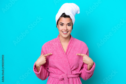 Young Brazilian woman with a bathrobe isolated on blue background with surprise facial expression