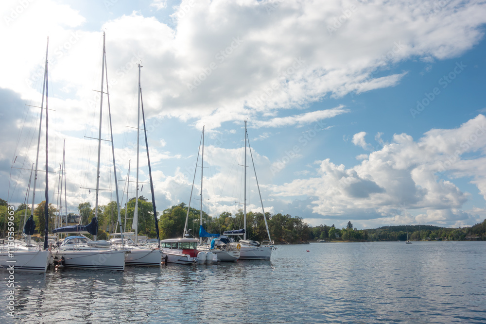 Small boat marina with sailboats and motorboats moored in summer by Gustavsberg harbor in Sweden in Stockholm archipelago Small boat marina with sailboats and motorboats moored in summer by Gustavsberg harbor in Sweden in Stockholm archipelago