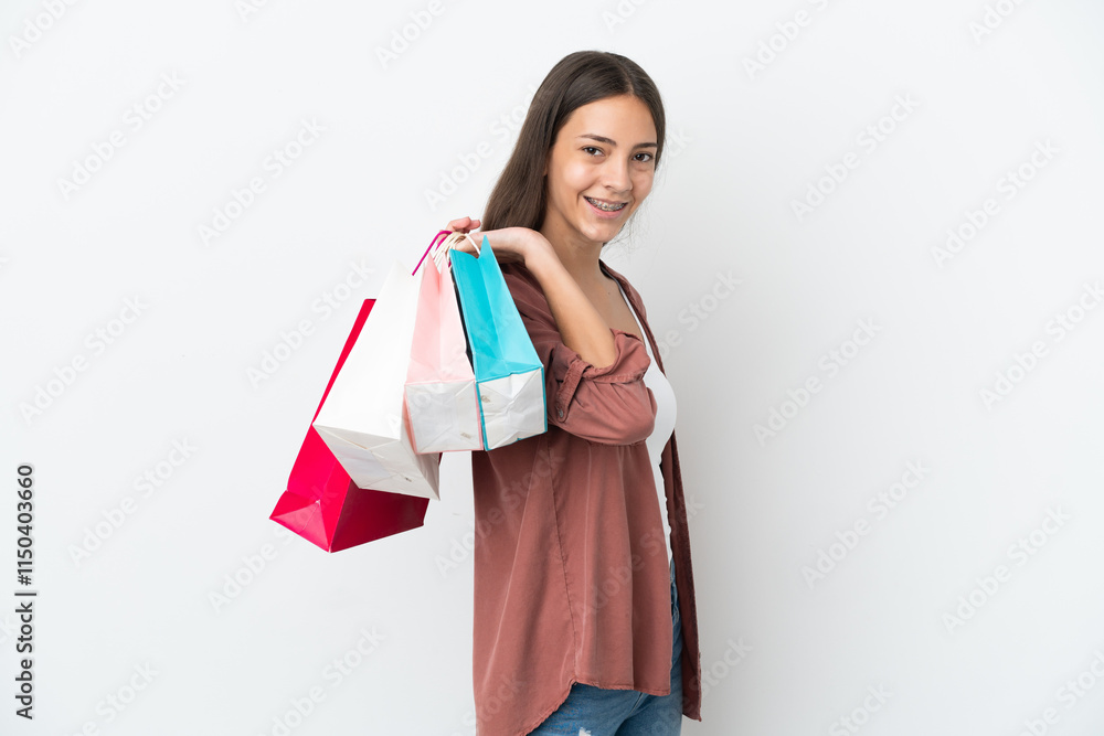 Young French girl isolated on white background holding shopping bags and smiling Young French girl isolated on white background holding shopping bags and smiling