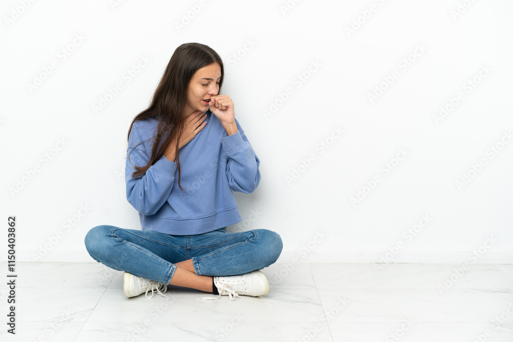 Young French girl sitting on the floor is suffering with cough and feeling bad Young French girl sitting on the floor is suffering with cough and feeling bad