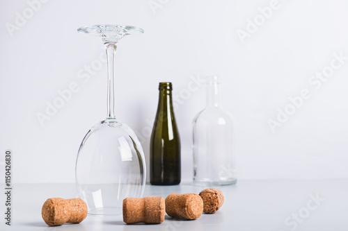 Alcohol abstinence, upside down wine glass among corks on table