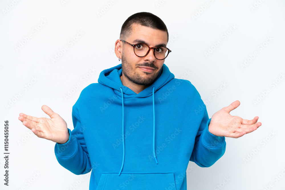 Young caucasian man isolated on white background With glasses and having doubts Young caucasian man isolated on white background With glasses and having doubts