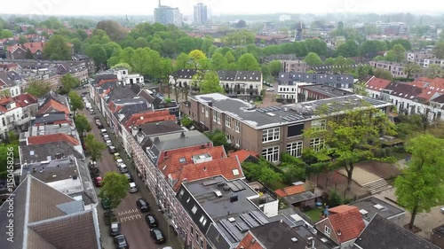 Drone footage of the Dutch city of Arnhem. Flying over the neighborhood Graaf Ottoplein E.O. towards a playground. In the background highrises in the citycentre can be seen. photo