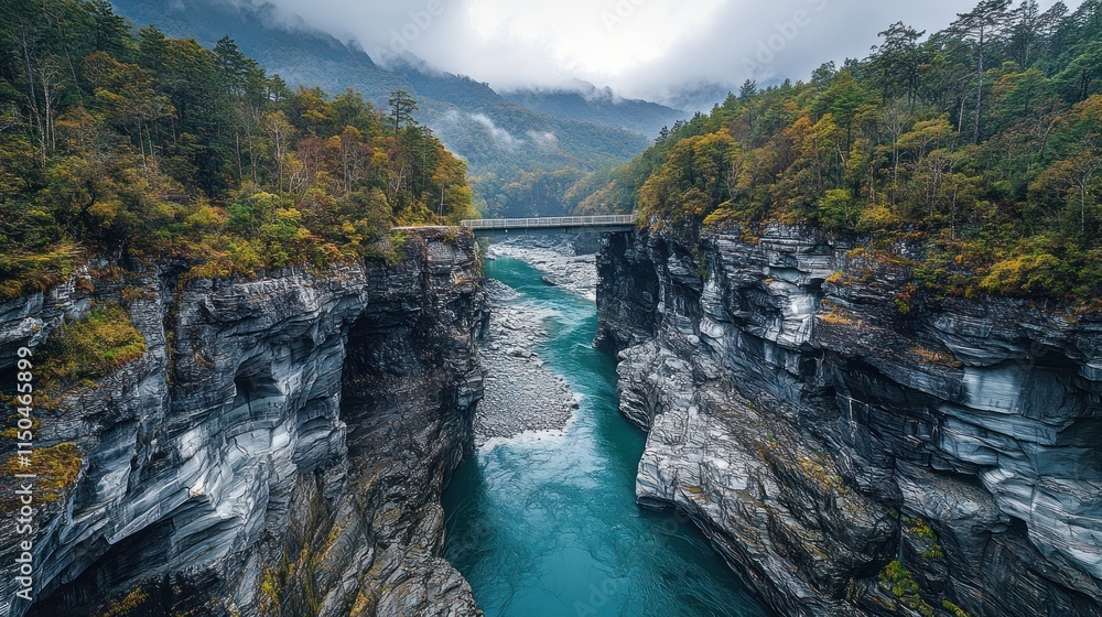 Aerial view of a turquoise river flowing through a dramatic gorge with autumn foliage and a bridge, showcasing rugged mountain scenery. Aerial view of a turquoise river flowing through a dramatic gorge with autumn foliage and a bridge, showcasing rugged mountain scenery.