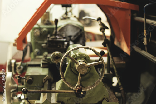 Detail of an old industrial conventionnal lathe, focused on handles for machining