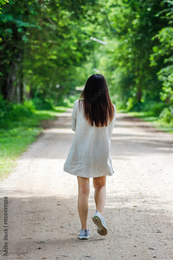 woman walking forward on the path to her intended destination and her journey along the path is a good exercise. feet walking along the path is the concept of walking to her destination and success. woman walking forward on the path to her intended destination and her journey along the path is a good exercise. feet walking along the path is the concept of walking to her destination and success.