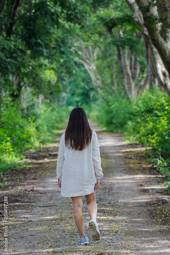 woman walking forward on the path to her intended destination and her journey along the path is a good exercise. feet walking along the path is the concept of walking to her destination and success.