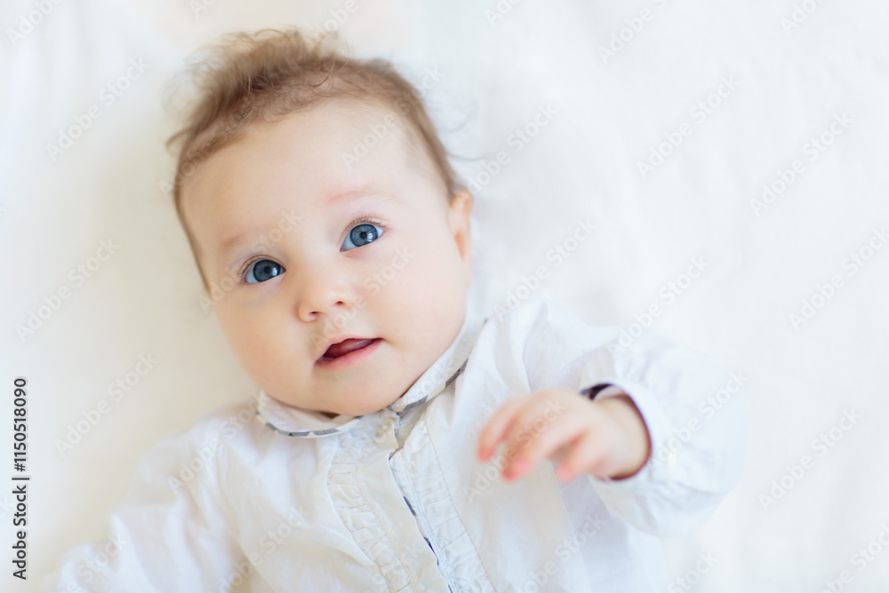 Little baby on white bed