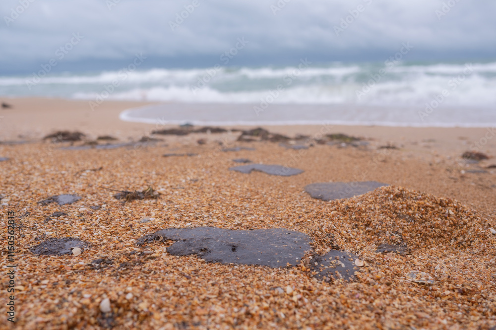 Fuel oil stains on the Black Sea coastline. Environmental disaster, environmental pollution. Oil spill Fuel oil stains on the Black Sea coastline. Environmental disaster, environmental pollution. Oil spill