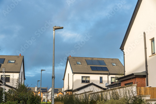 DEC 23, 2024 - CORK, IRELAND. Solar panels installed on the rooftops of a modern residential housing estate in Ireland. Heathfield, Carriganarra Ballincollig