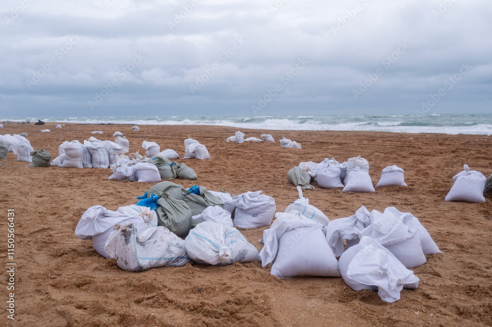 A pile of bags of collected fuel oil on the coastline after an environmental disaster on the Black Sea A pile of bags of collected fuel oil on the coastline after an environmental disaster on the Black Sea