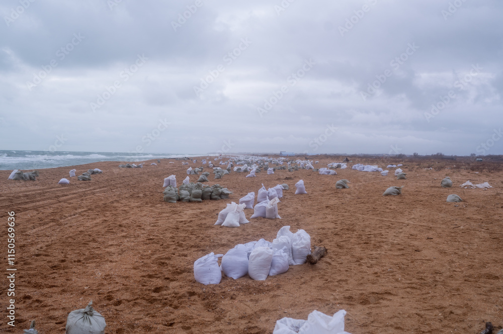A pile of bags of collected fuel oil on the coastline after an environmental disaster on the Black Sea A pile of bags of collected fuel oil on the coastline after an environmental disaster on the Black Sea