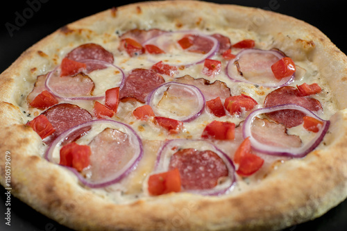 details of the pizza application; juicy pizza from the oven with mushrooms, tomatoes and bacon and sprinkled with parmesan cheese