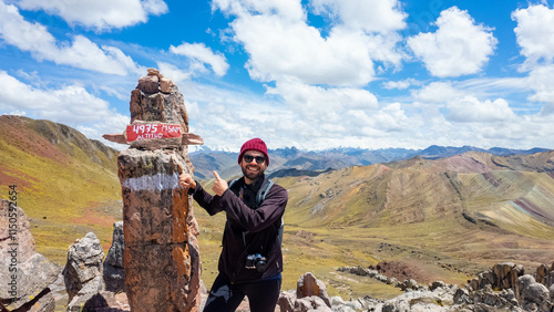 Young traveler on the peak of a mountain in Andes range in Peru