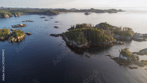 Hazy sunset over a small archipelago of smaller islands sitting the the calm waters of West Coast British Columbia