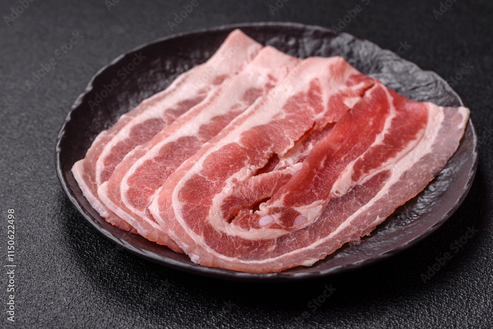 Fresh raw bacon sliced with spices and herbs Fresh raw bacon sliced with spices and herbs