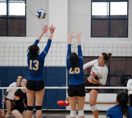 Volleyball player hitting the ball over the block