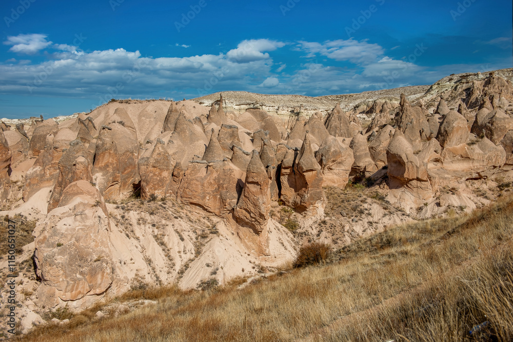 Fairy Chimneys are world-famous natural formations located in the Cappadocia region of Turkey. They were formed by the wind and water erosion of volcanic tuff layers over thousands of years.