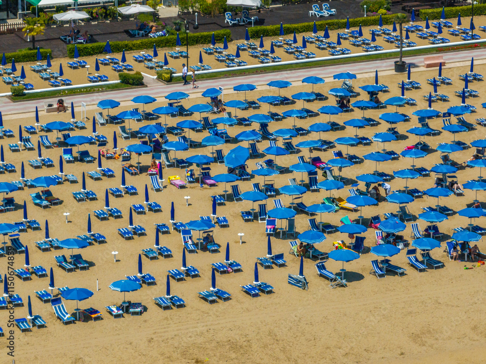 Fototapeta premium Italy, Jesolo near Bibione. Lido di Jesolo, or Jesolo Lido, is the beach area of the city of Jesolo in the province of Venice, Aerial View with sandy beach and with an endless parasols