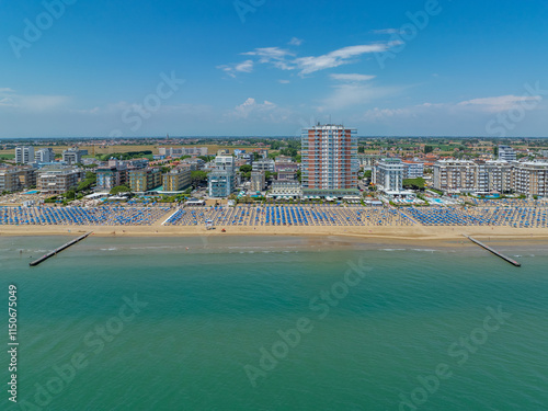 Italy, Jesolo near Bibione. Lido di Jesolo, or Jesolo Lido, is the beach area of the city of Jesolo in the province of Venice, Aerial View with sandy beach and with an endless parasols