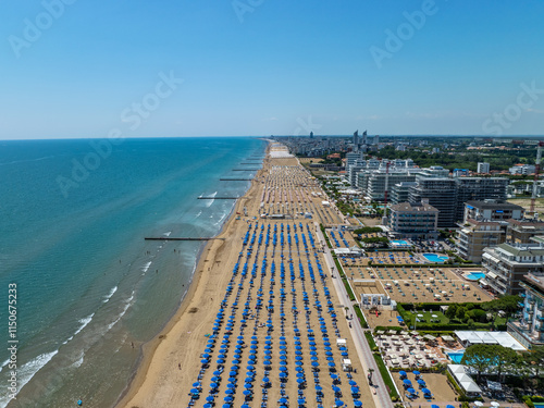 Italy, Jesolo near Bibione. Lido di Jesolo, or Jesolo Lido, is the beach area of the city of Jesolo in the province of Venice, Aerial View with sandy beach and with an endless parasols