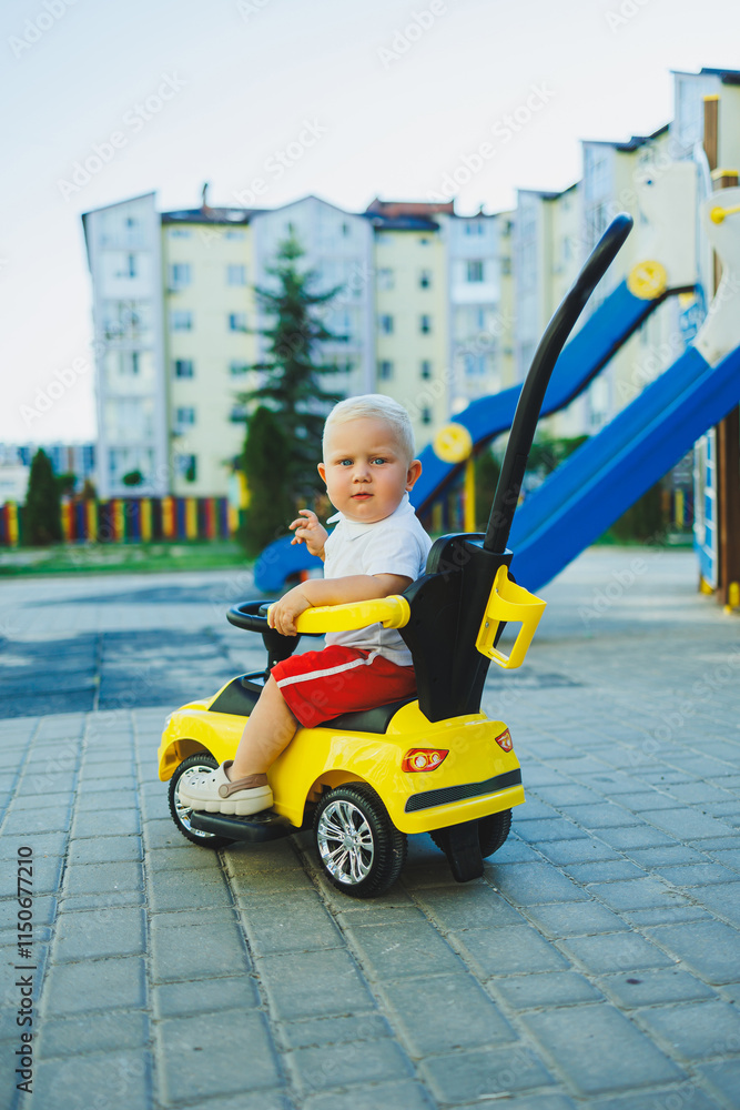 A little boy rides a tolocar. Tolokar for babies. Children's car for skating. A little boy rides a tolocar. Tolokar for babies. Children's car for skating.