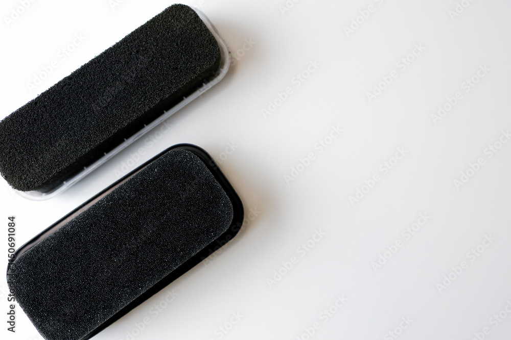 Sponges for black leather shoes lie on a white background with space for text. High quality photo Sponges for black leather shoes lie on a white background with space for text. High quality photo