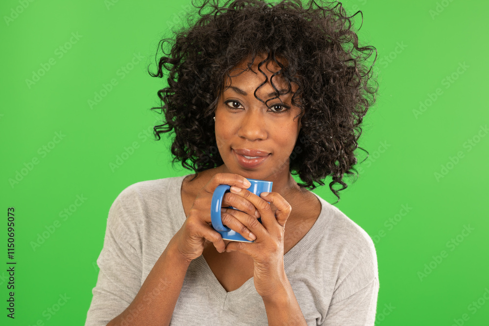 Close up of pretty black woman holding coffee and smiling at camera Close up of pretty black woman holding coffee and smiling at camera