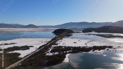 Wallpaper Mural The Lake Cerknica in the winter, partialy frozen lake, snowy fields on blue sky day, flying above, aerial footage, drone shots, Cerknica Lake, Slovenia Torontodigital.ca