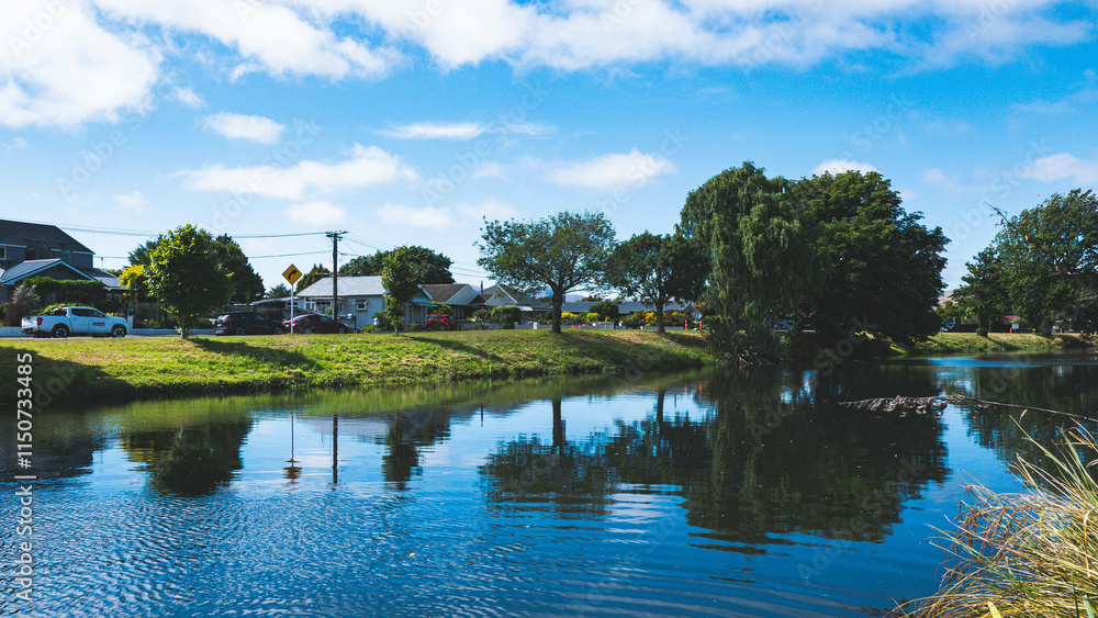 Obraz premium Beautiful day at the park river blue skies water reflection Christchurch city New Zealand