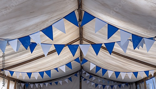 Blue and white Oktoberfest bunting strung across a rustic festival tent ceiling