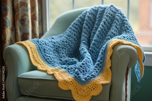 Cozy blue and yellow crocheted blanket draped over a vintage armchair in a wa...
