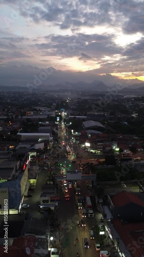 Drone view of traffic light intersection in Purwakarta, West Java. Beautiful sunset sky and busy city. 