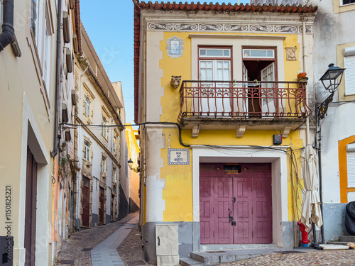 Old and narrow street in historical center of Coimbra, Portugal photo