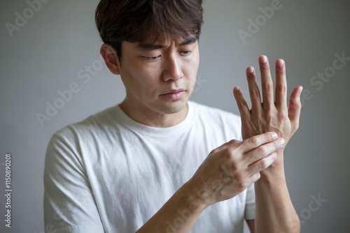 Man Closely Examining His Hand Indoors photo