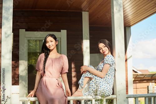 Wallpaper Mural Asian beauty taking photos and enjoying the scenery outside the villa gate in summer Torontodigital.ca