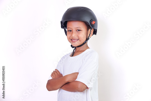 A young asian boy smiles confidently while wearing a helmet and a white shirt. photo