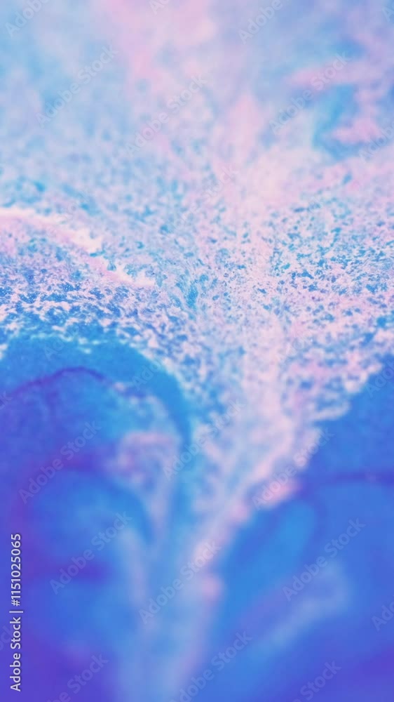 Vertical video. Ink drip. Sparkling fluid flow. Defocused purple blue pink color shiny glitter particles acrylic paint emulsion liquid pigment blend motion abstract art background. Vertical video. Ink drip. Sparkling fluid flow. Defocused purple blue pink color shiny glitter particles acrylic paint emulsion liquid pigment blend motion abstract art background.