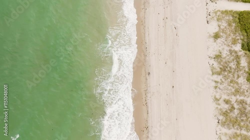 Clear water waves of the Atlantic Ocean crashing into the beach in Fort Lauderdale Florida photo