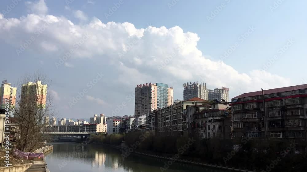 Beautiful time lapse of blue sky and white clouds over a bustling urban landscape Beautiful time lapse of blue sky and white clouds over a bustling urban landscape