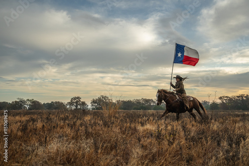 Woman Wearing Cowboy Hat Riding Running Horse While Holding Large Texas Flag In Grassy Field With Cloudy Sky At Sunset