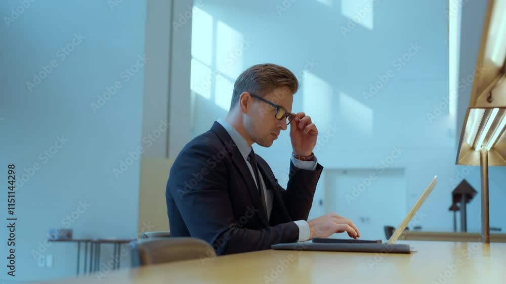 Caucasian business man ceo trader using laptop computer, typing, working in modern office Caucasian business man ceo trader using laptop computer, typing, working in modern office