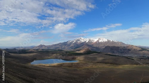 Wallpaper Mural Serene lake laguna Willimanco in Esquel, Chubut, nestled amidst rolling hills and the snow-capped Andes in the distance, attracting hikers and nature enthusiasts, drone slow motion establishing shot Torontodigital.ca