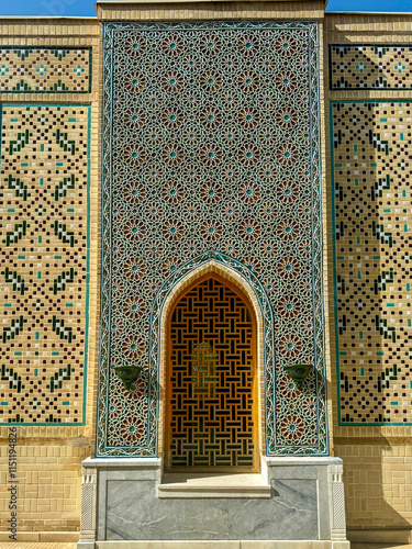 Ornate Mosaic Wall with Geometric Patterns and an Arched Entrance photo