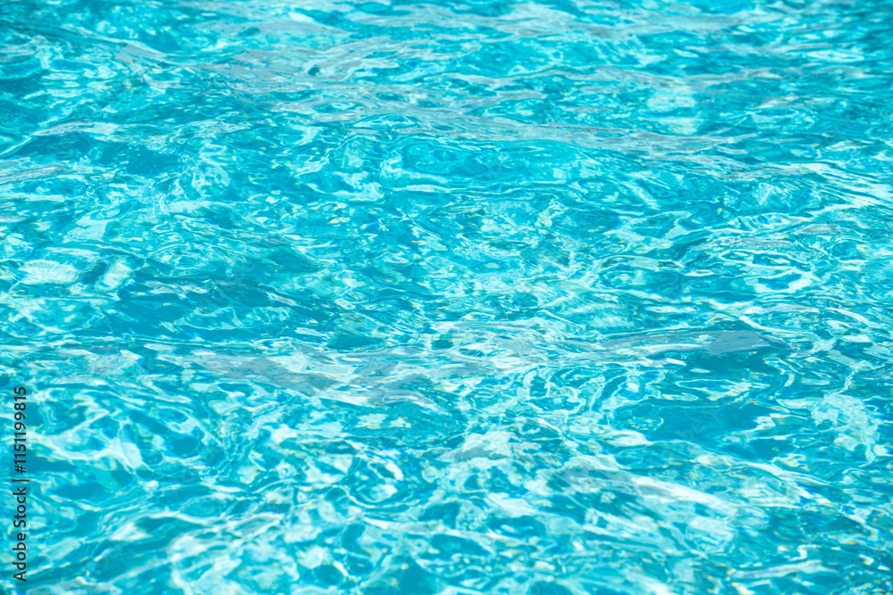 Blue pool water background. Blurred transparent clear calm water surface texture. Water waves in sunlight with copy space. Blue pool water background. Blurred transparent clear calm water surface texture. Water waves in sunlight with copy space.