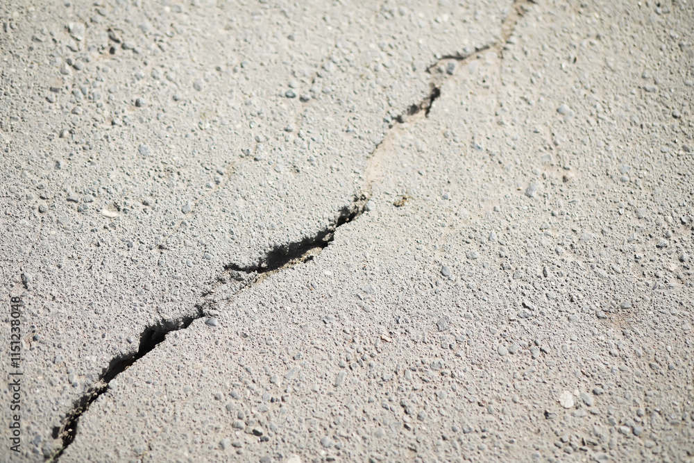 Close-Up of Asphalt with Large Crack Illustrating Structural Damage and Road Deterioration Close-Up of Asphalt with Large Crack Illustrating Structural Damage and Road Deterioration