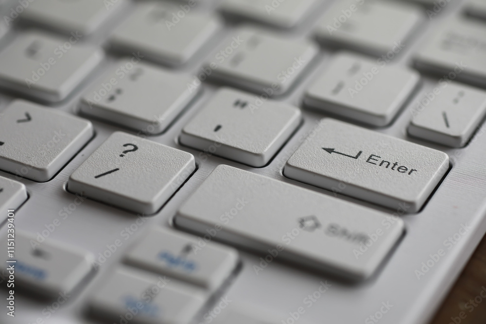 Close-up of Modern White Keyboard with Enter Key Highlighted Close-up of Modern White Keyboard with Enter Key Highlighted