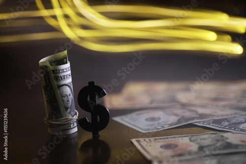 Cash Money Roll with Dollar Symbol and Blurred Yellow Lights in Background photo